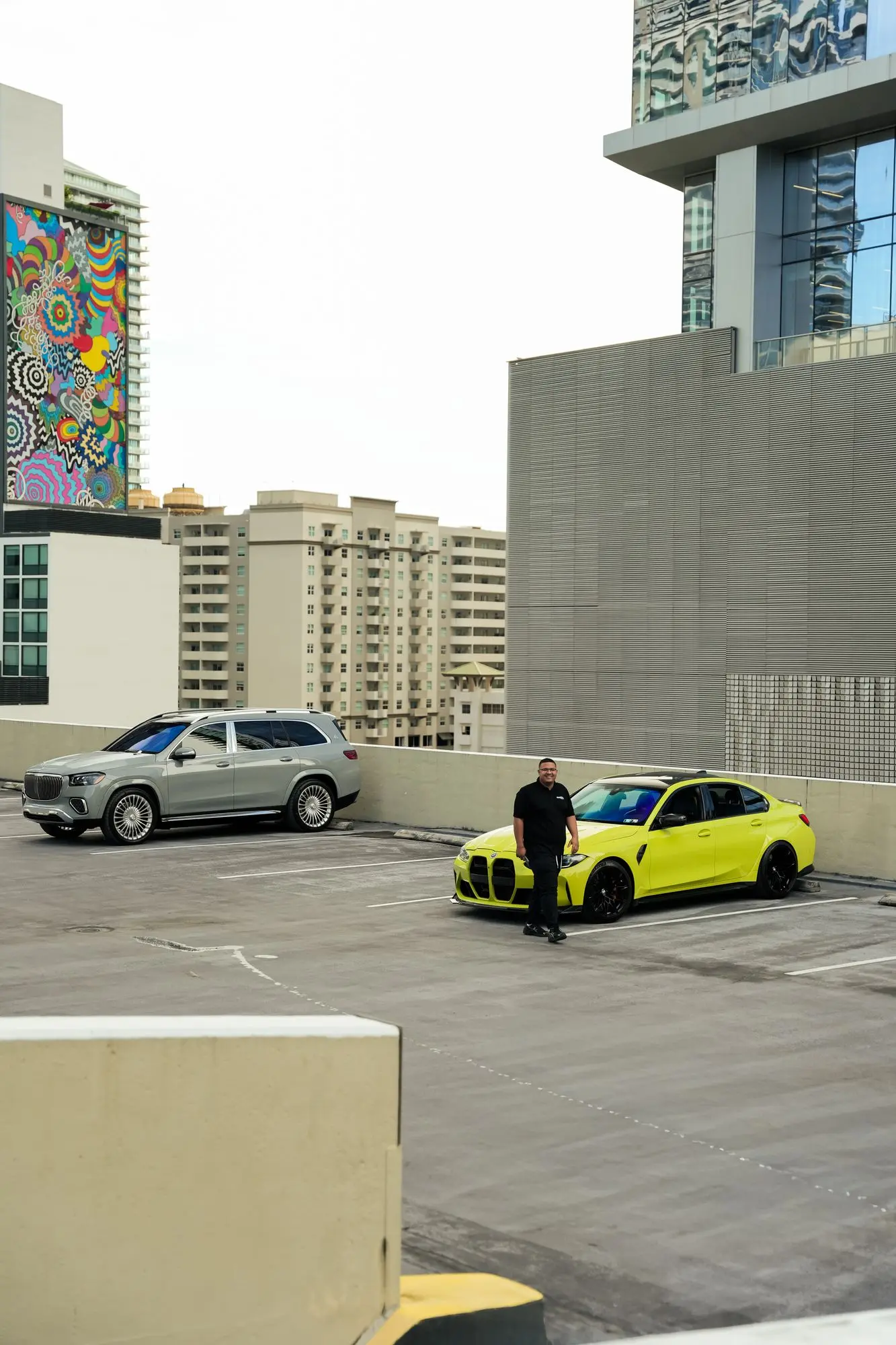 A BMW M3 Competition and a Range Rover on a Brickell rooftop